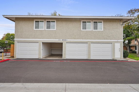 Front view of a two-story building with multiple garage doors.