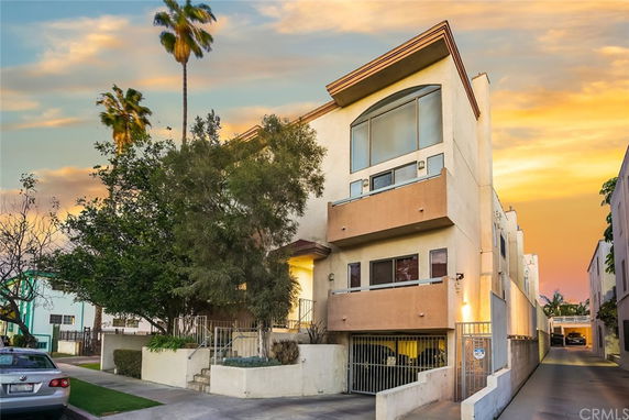 Front view of a multi-story residential building with a modern design.