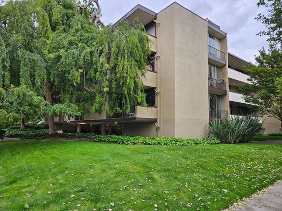 Front view of a multi-story residential building with balconies.