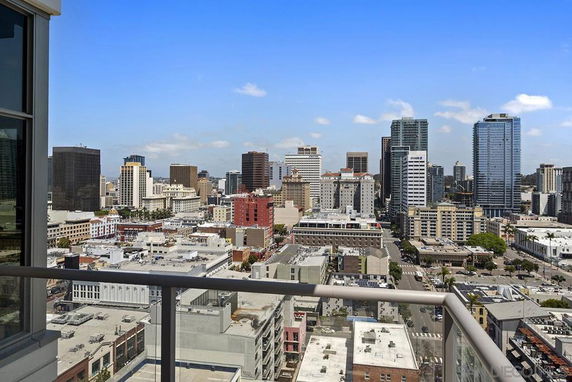 Skyline view of a city with various high-rise buildings and a clear blue sky.