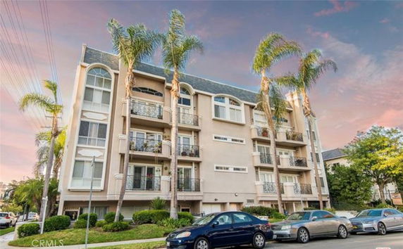 Front view of a multi-story residential apartment building with balconies.