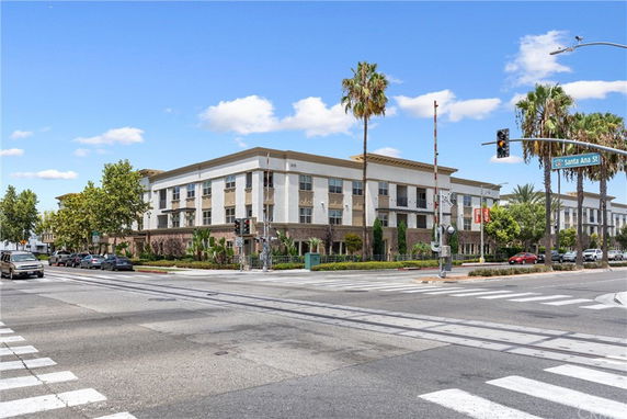 Front view of a three-story building at a street intersection.