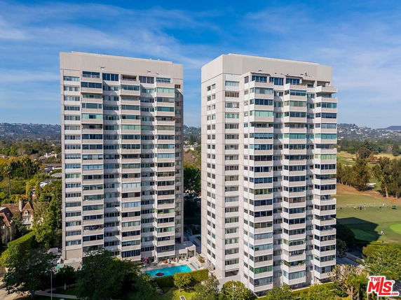 Front view of two high-rise residential buildings.