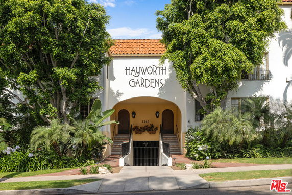 Front view of a building labeled 'Hayworth Gardens' with a central entrance and surrounding greenery.