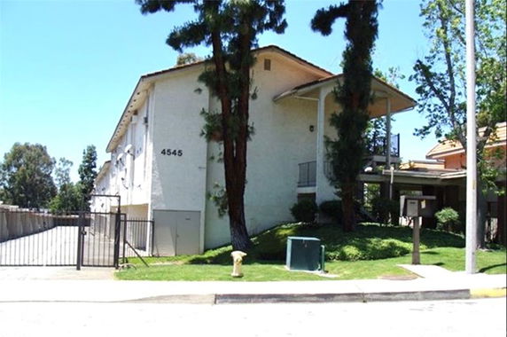 Front view of a two-story building with a gated entrance.