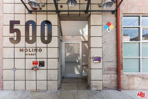 Front elevation view of a building with large number '500' and 'Molino Street' signage above the entrance.