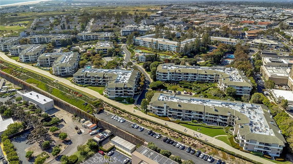 Panoramic view of a residential complex with multiple buildings and parking areas.