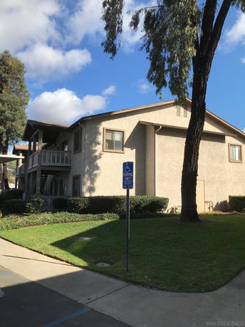 Front view of a two-story residential building with a balcony.