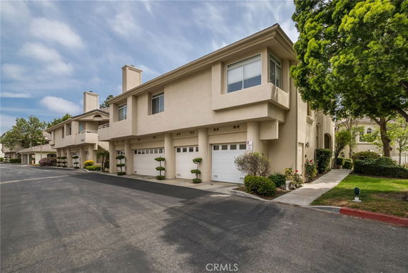 Front view of a townhouse complex with garages.