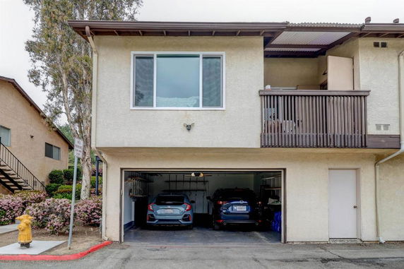 Front view of a two-story house with an open garage.