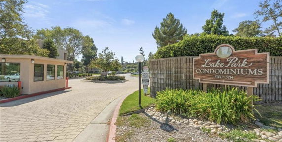 Front view of a condominium entrance with a sign for Lake Park Condominiums.