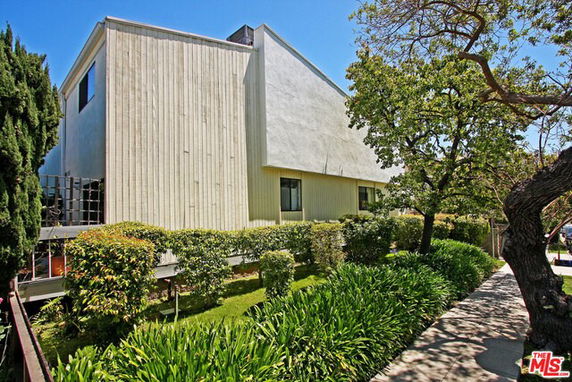 Side view of a modern two-story building with large windows.