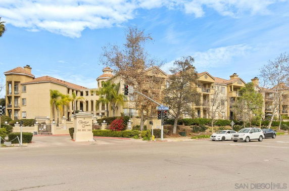 Front view of a multi-story residential building with a Mediterranean architectural style.