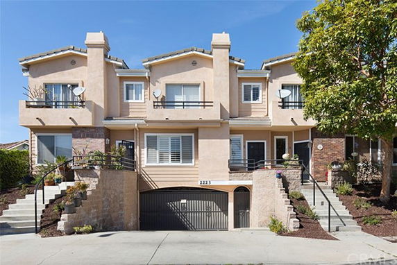 Front view of a multi-story townhouse with a garage entrance.