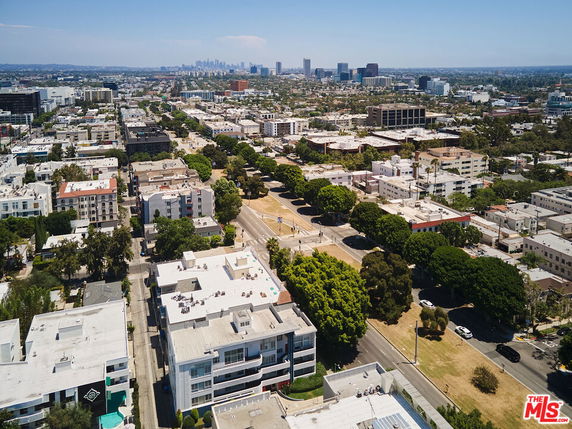 Panoramic view of a city with numerous buildings and landscaped streets.