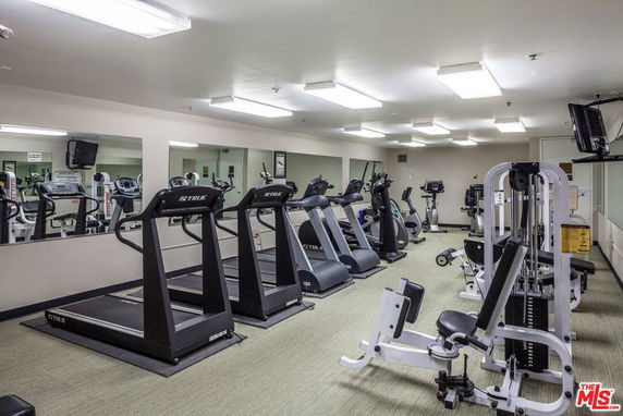 Indoor gym area with treadmills and exercise equipment.