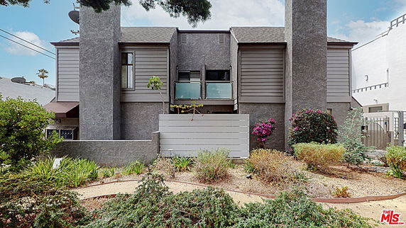 Front view of a two-story house with a unique facade design.
