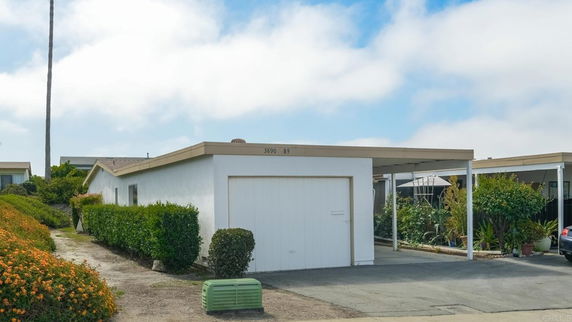 Front view of a single-story house with an attached carport.