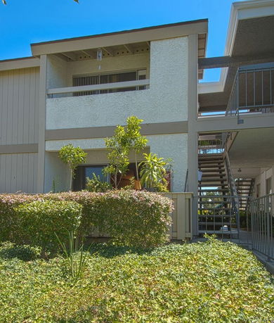Front view of a two-story building with an exterior staircase.
