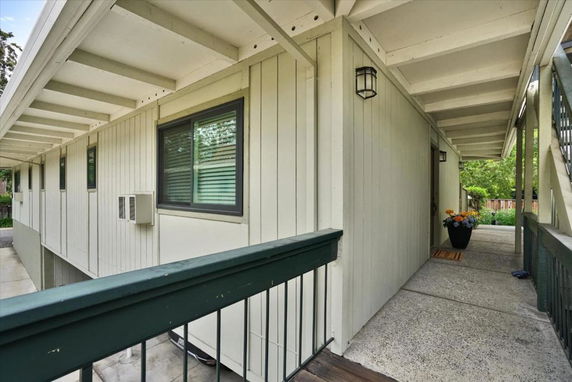 Exterior view of a building with a covered walkway and windows.