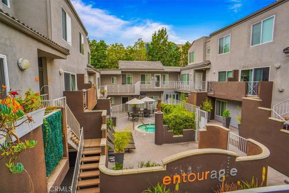 Courtyard view of an apartment complex with a small swimming pool.