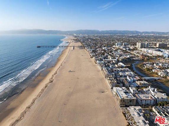Panoramic view of a beach with adjacent city buildings.