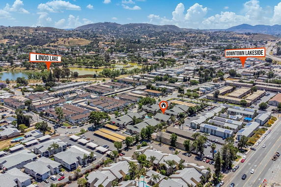 Aerial view of a residential and commercial area with signage pointing to Lindo Lake and Downtown Lakeside.