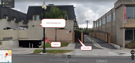 Front view of a multi-story building with a gated entry and underground parking access.