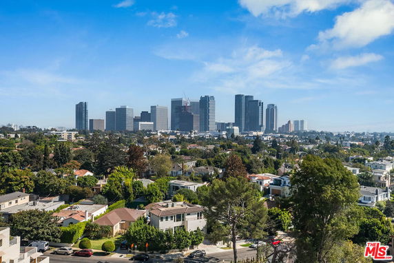 Panoramic view of a cityscape with high-rise buildings and residential area in the foreground.