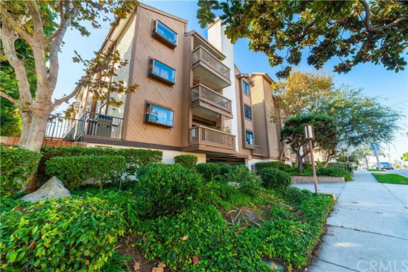 Front view of a multi-story residential building with balconies.