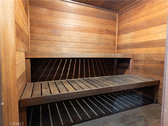 Interior view of a wooden sauna room with bench seating.