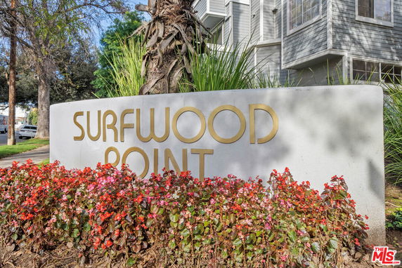 Front view of a building with the Surfwood Point signage.