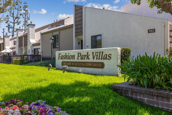Front view of Fashion Park Villas with multiple chimneys and distinct architecture.