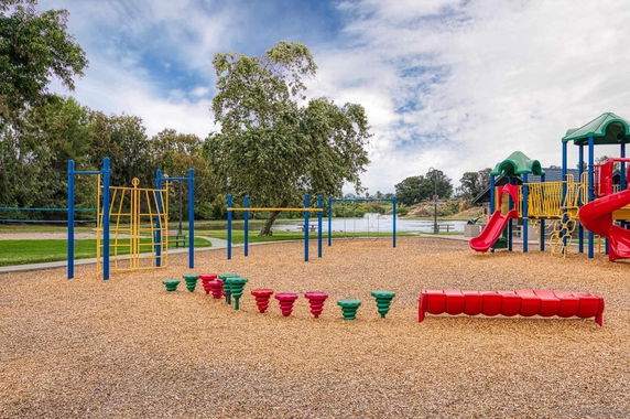 Outdoor playground with various play structures and slides.