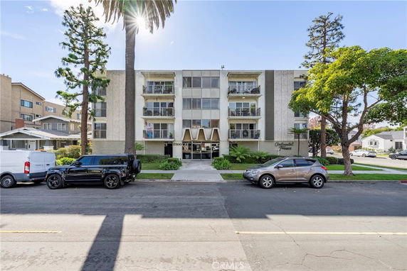 Front view of a multi-story residential building with balconies.