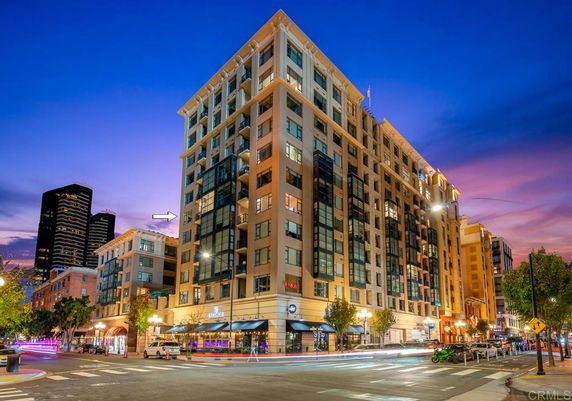 Front view of a multi-story building with modern architecture at dusk.