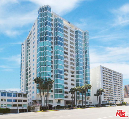 Front view of a modern high-rise building with glass windows.
