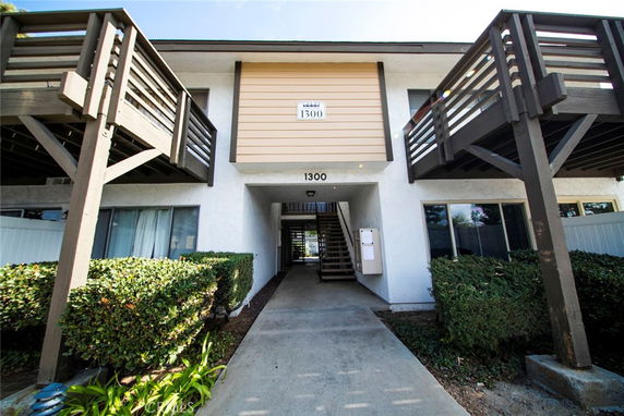 Front view of a two-story apartment building with balconies.