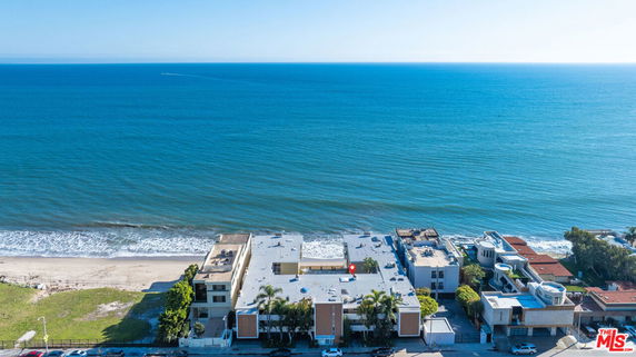 Panoramic view of beachfront properties with ocean in the background.