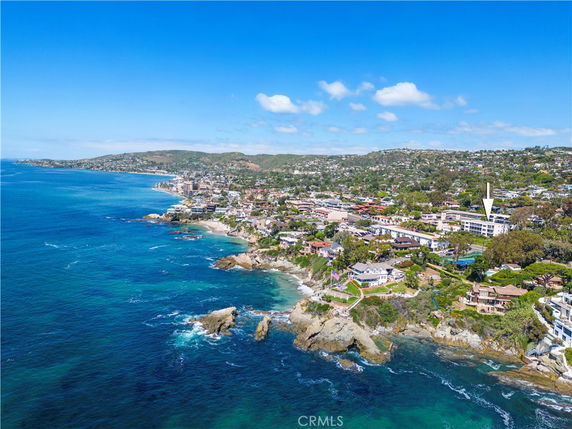 Wide angle view of coastal buildings and shoreline.
