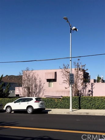 Front view of a modern two-story building with a pink exterior.