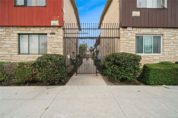 Front view of a residential building with a gated entryway.