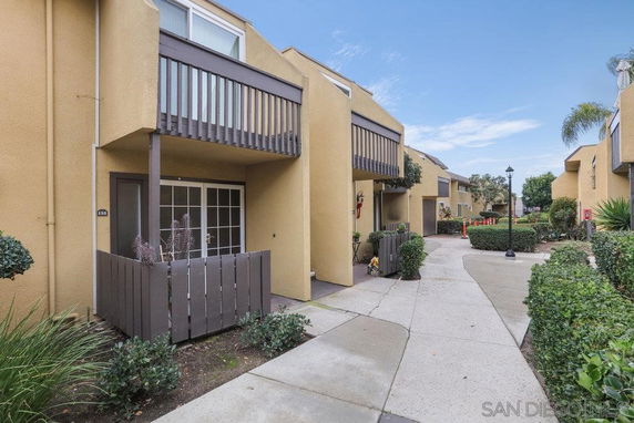 Front view of a row of modern townhouses with balconies.