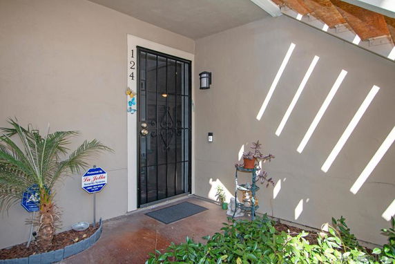 Front view of a residential entrance with a security door and house number.