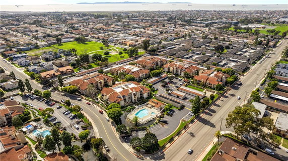 Panoramic aerial view of a residential neighborhood with multiple buildings and roads.