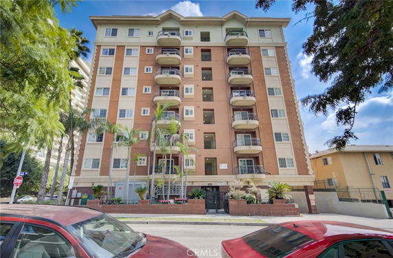 Front view of a multi-story residential building with balconies.