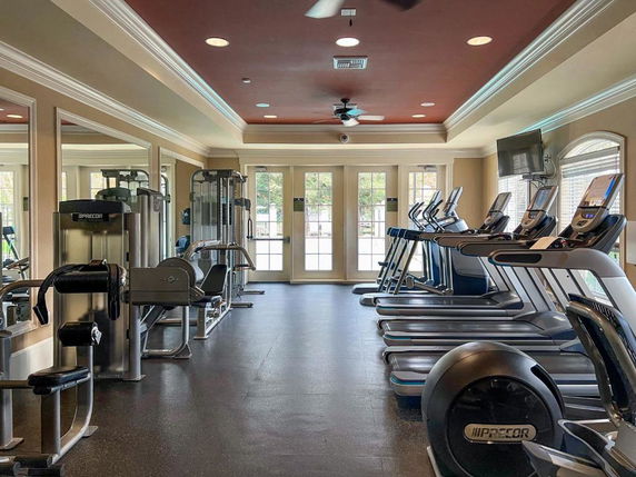 Interior view of a gym with exercise equipment and treadmills.