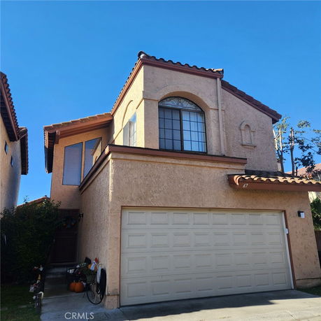 Front view of a two-story house with a double garage.