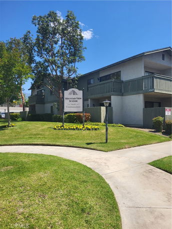 Front view of a condominium building with balconies.