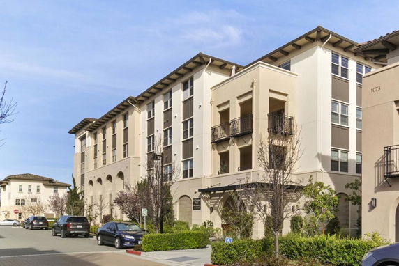 Front view of a multi-story residential building with balconies.